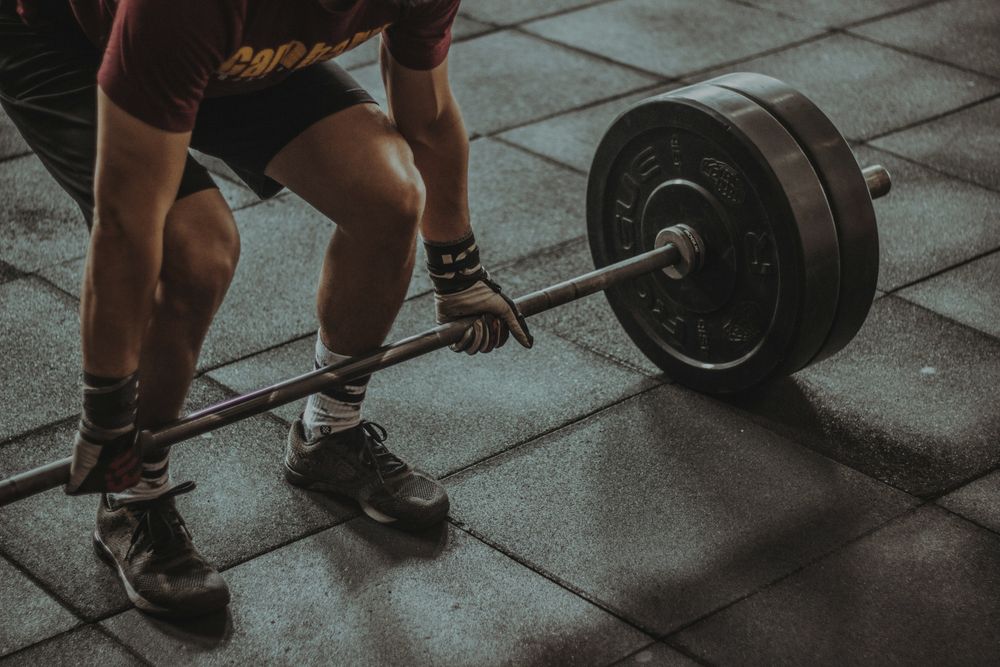 A shot of hands getting ready to dead-lift a very heavy bar